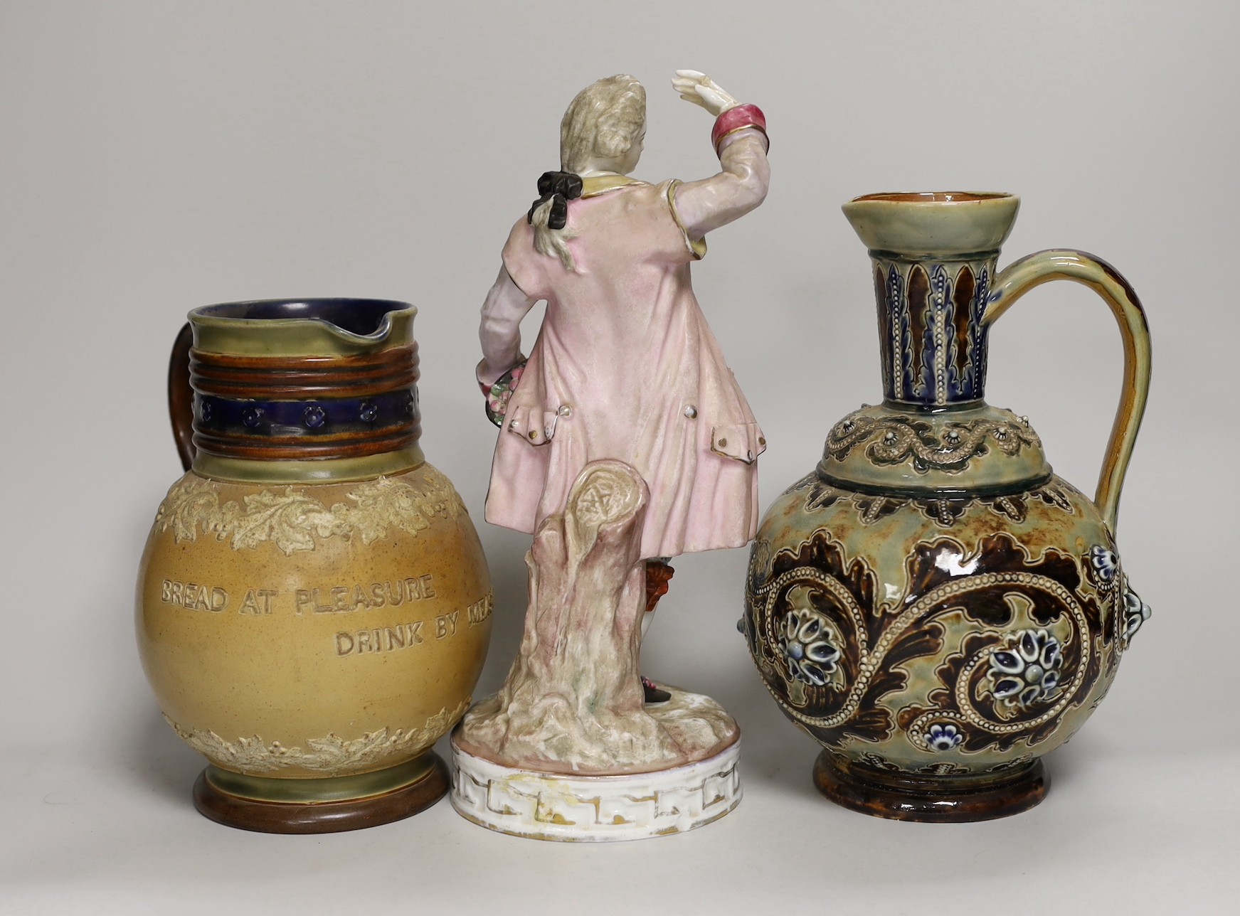 A group of six Doulton Lambeth stoneware vessels, tallest 22.5 cm and a French porcelain figure of a gentleman (7)